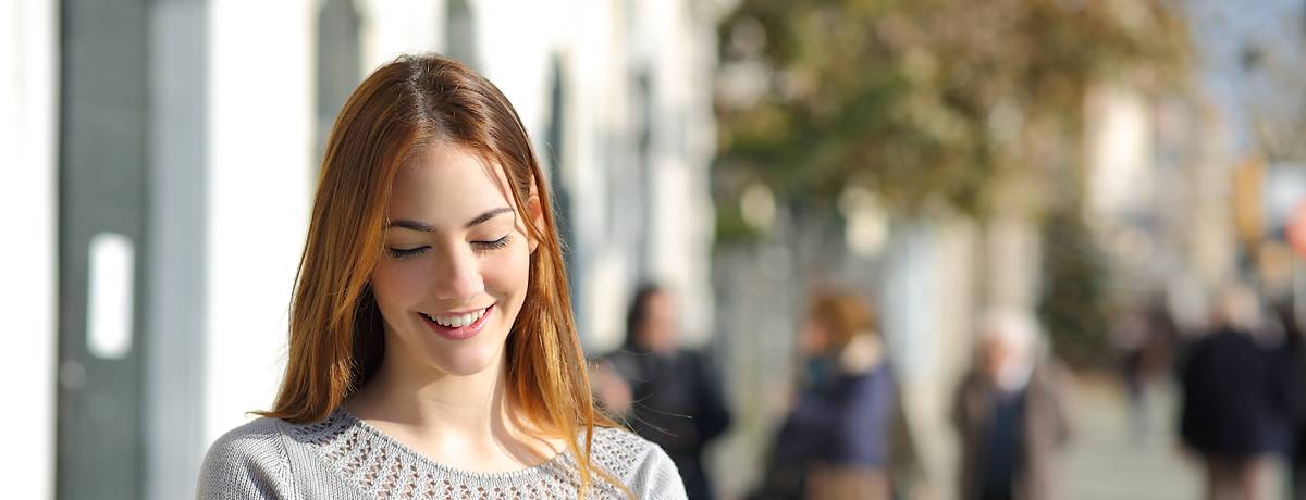 Young woman smiling outside clinic