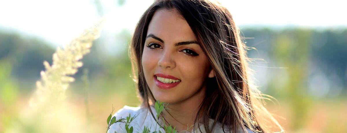 Smiling young woman in field